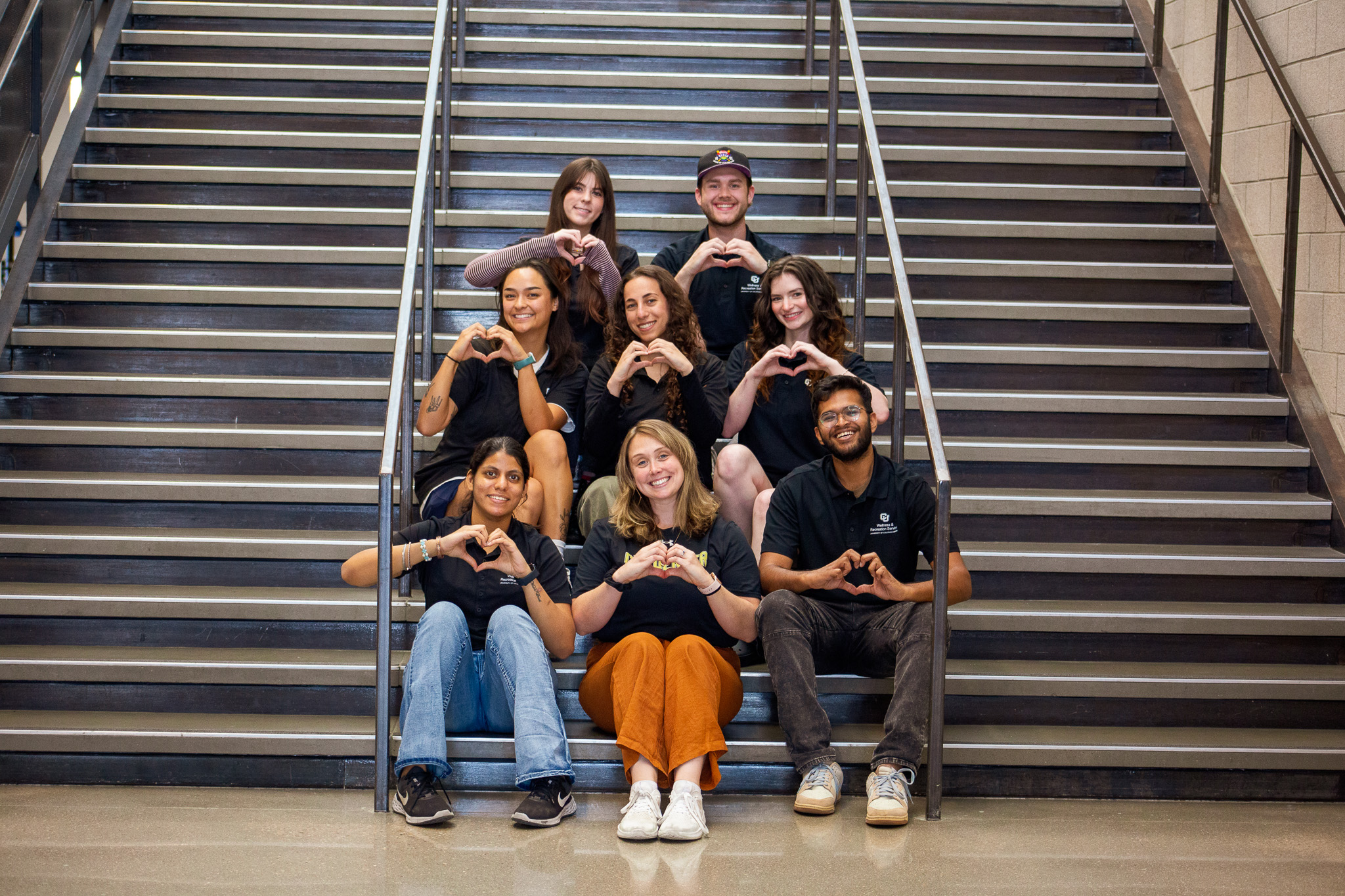 Wellness Associate Staff sitting on the wellness center stairs