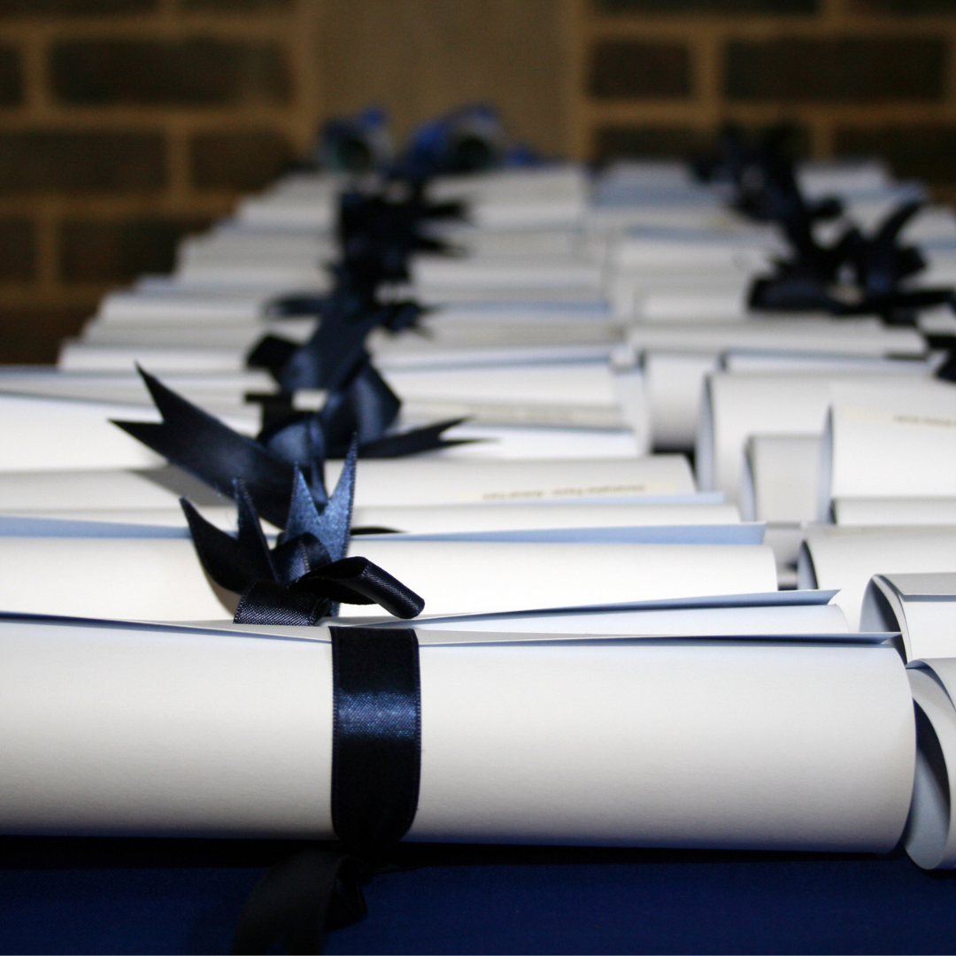 table with certificates rolled up and tied with ribbon