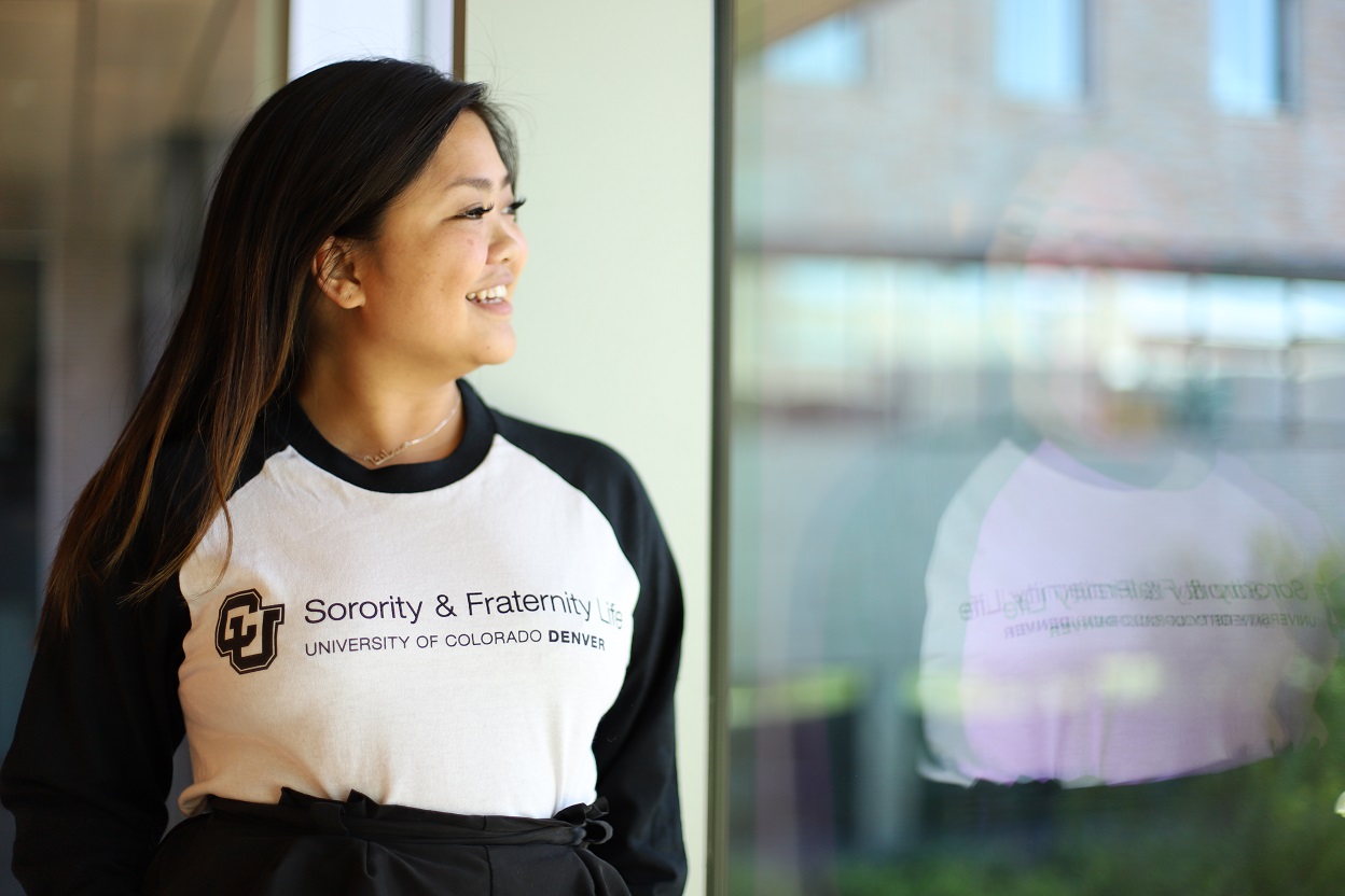 woman smiling looking out a window