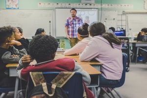 a male teacher standing in front of class