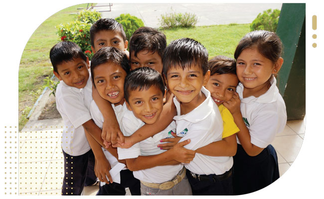 Group of Guatemalan children hugging and smiling