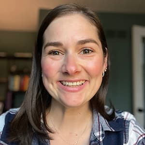 Gabi Dargis headshot, smiling with her teeth.