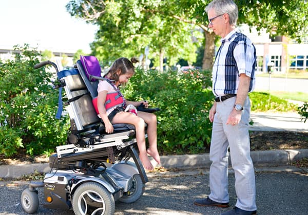 A child tries out a newly designed mobility chair