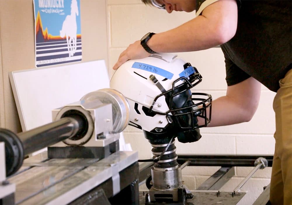 A student works on a safer football helmet