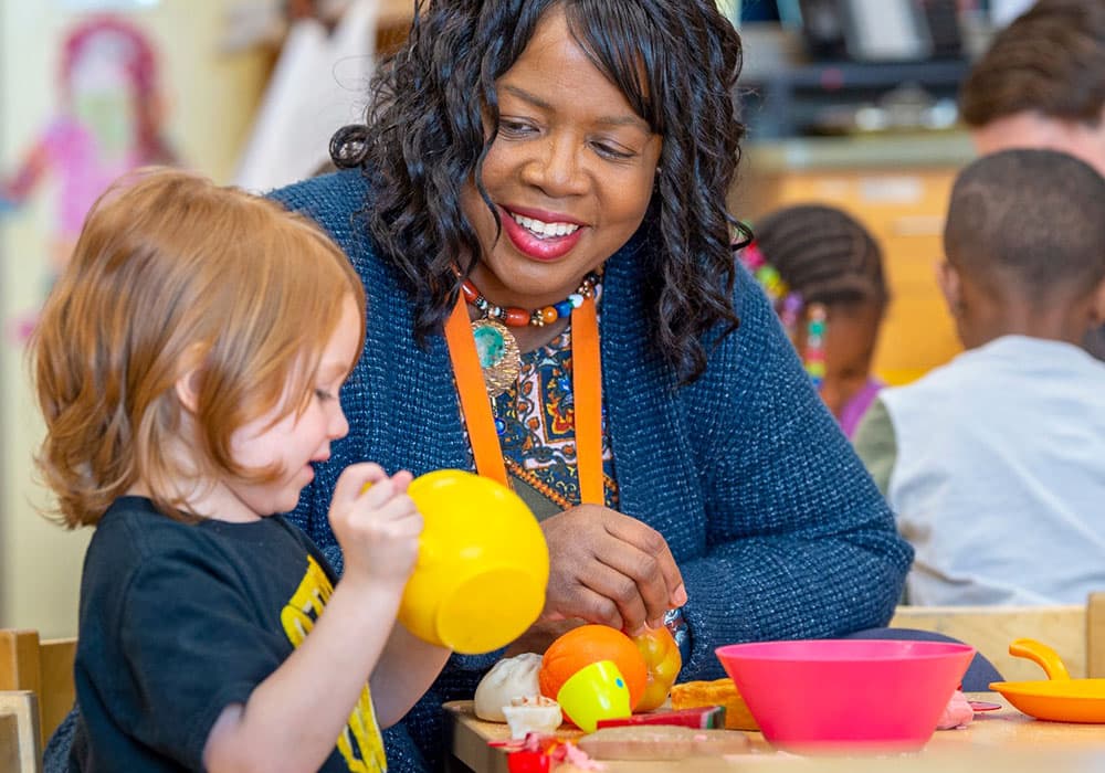 An early childhood teacher with a student