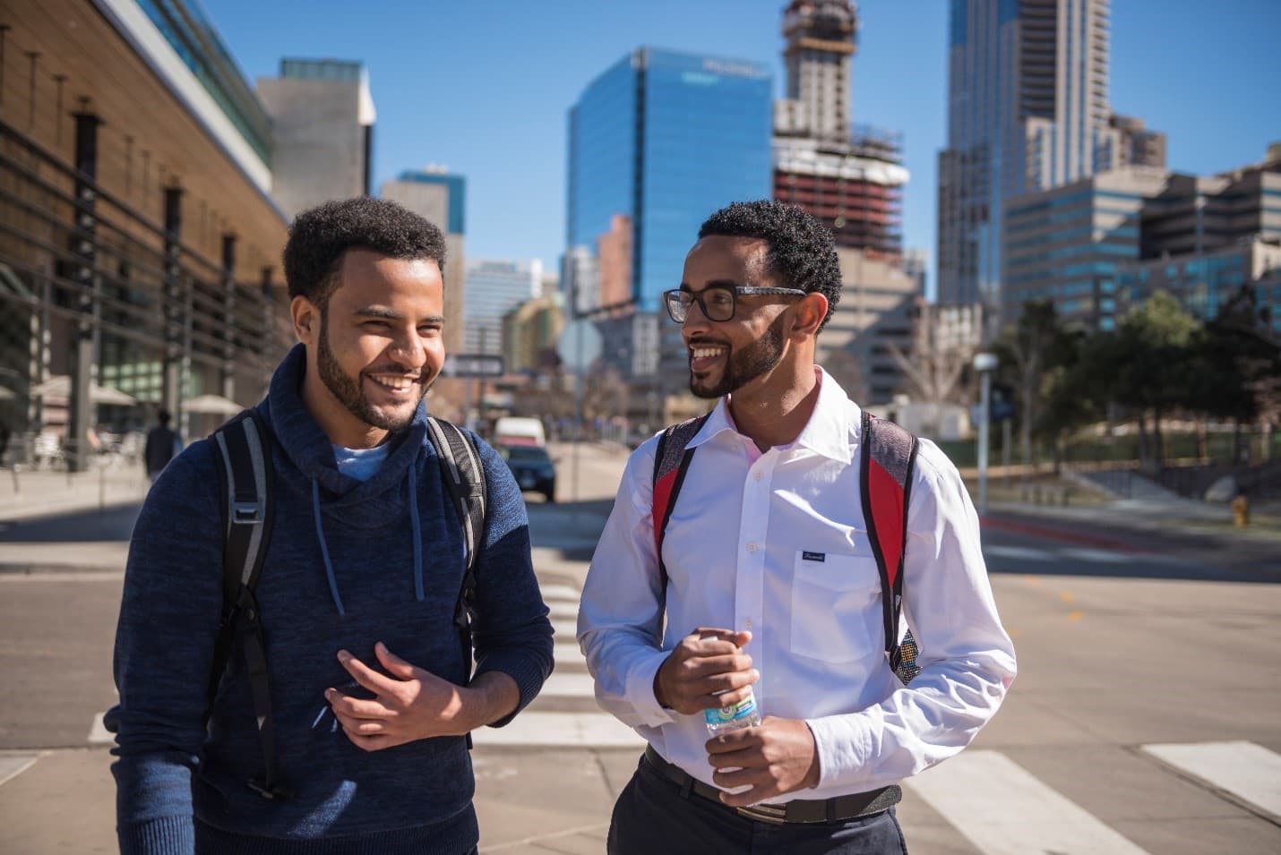 Students laughing outside of student commons building