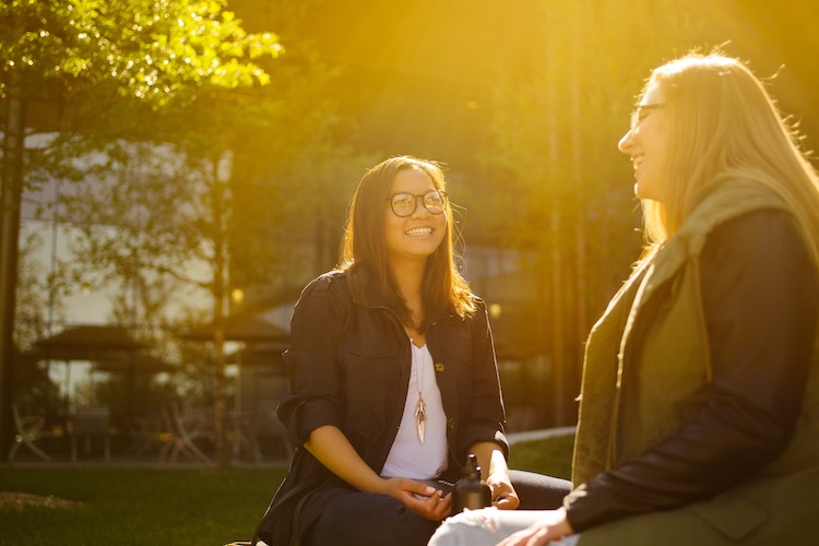 CU Denver students talking outside on a sunny day