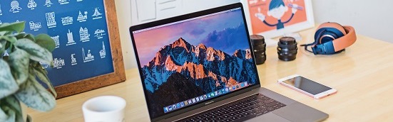 Image of a laptop, smart phone, and a cup of coffee on a desk