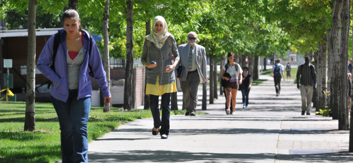 students walking down campus sidewalk