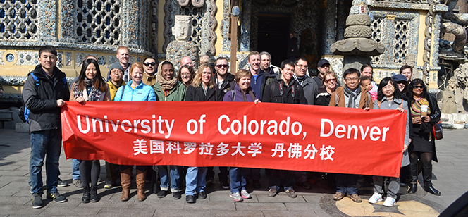 students holding UCD banner in English and Chinese