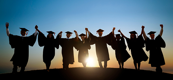 silhouette of college graduates at sunrise