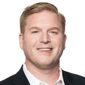 close-up headshot of Steve Ewell smiling in business suit