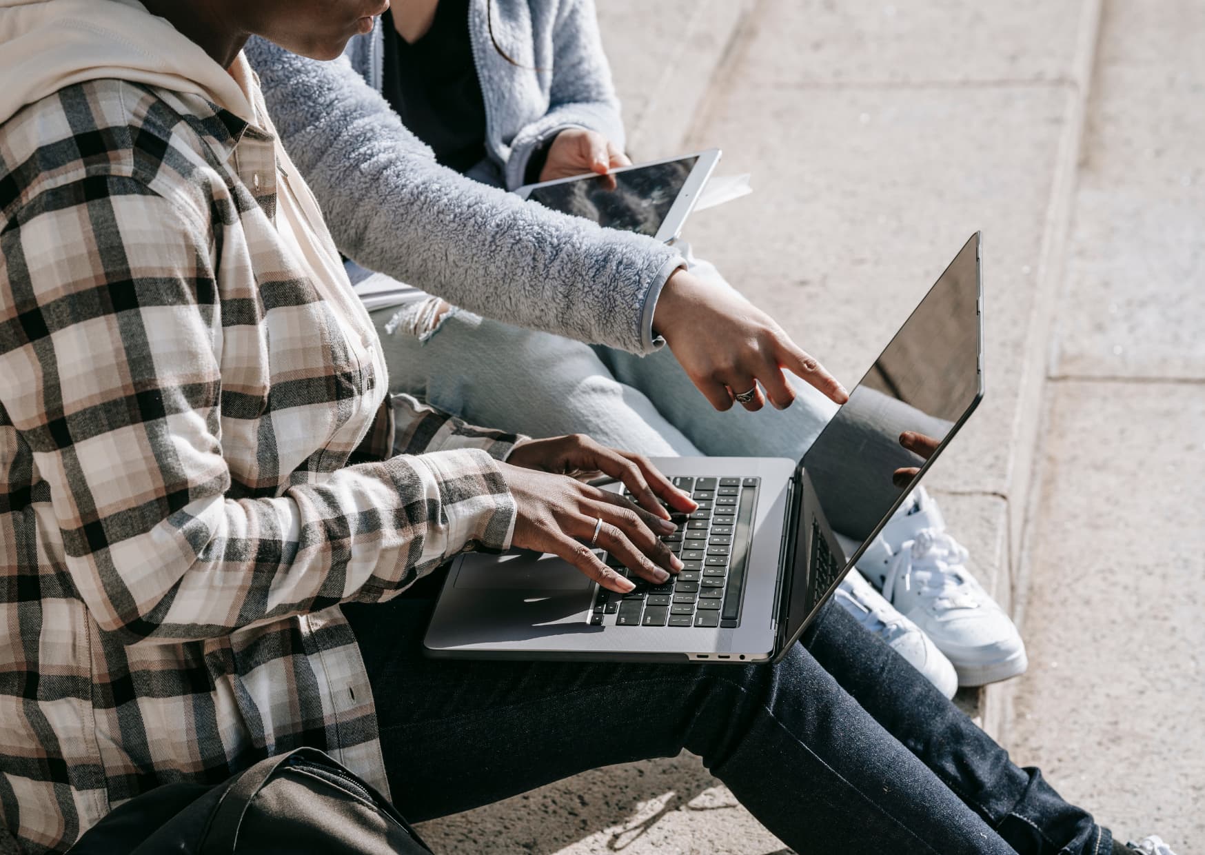 People researching on a computer and iPad