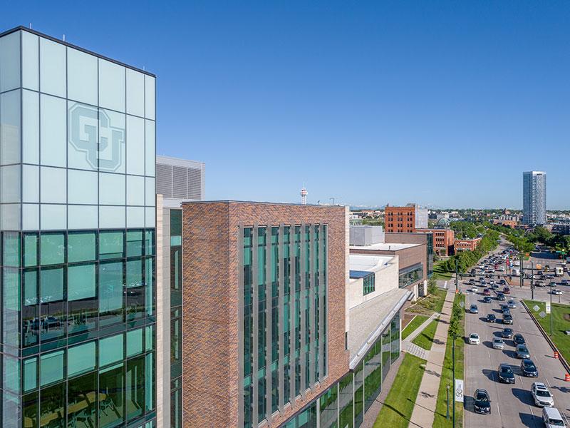 CU Denver campus with logo and blue sky